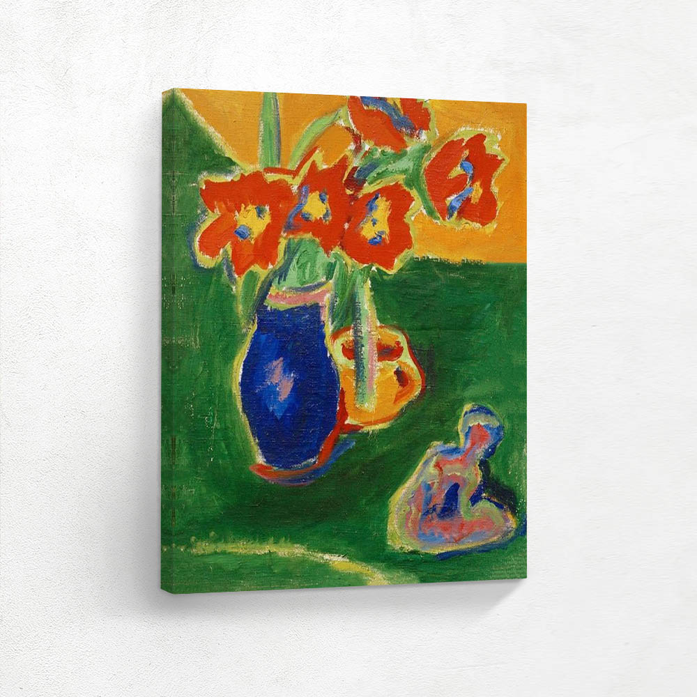 Red tulips in blue vase with sculpture