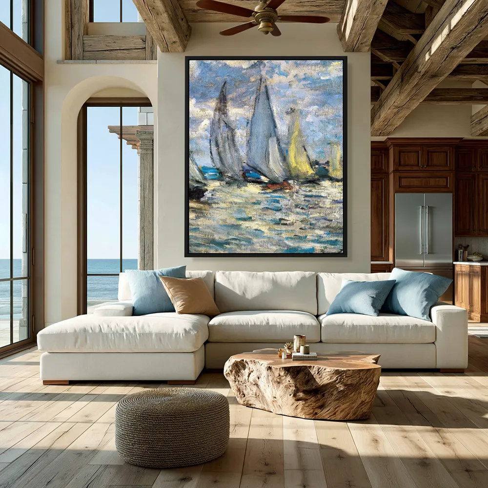 Coastal living room with framed sailboat wall art above a cream sofa, blue cushions, and exposed wood beams